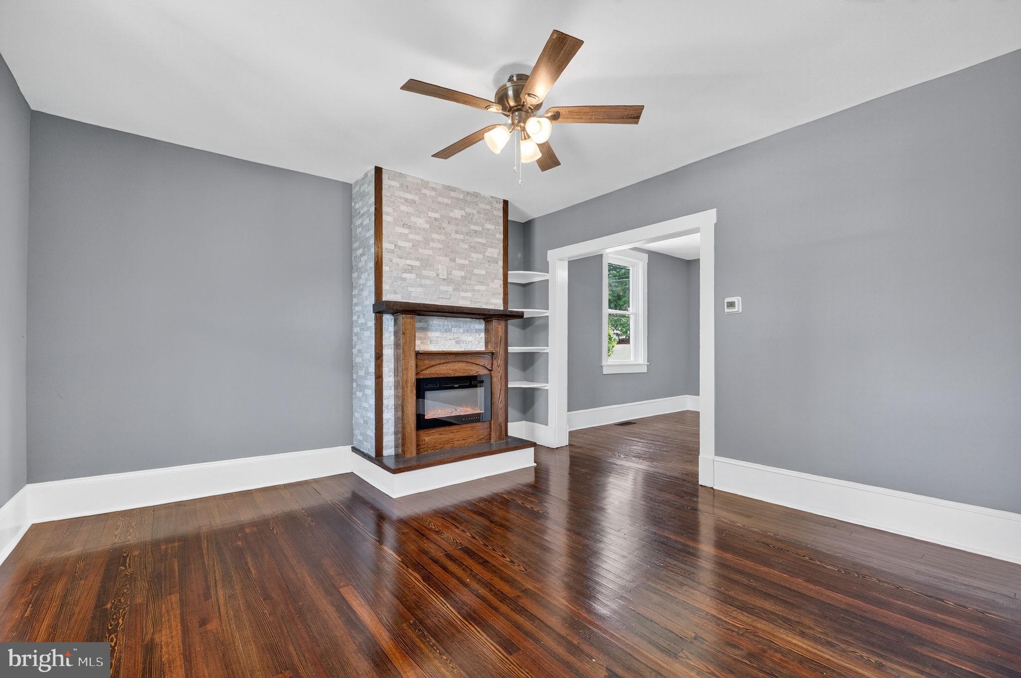 Living room w/ fireplace & new ceiling fan