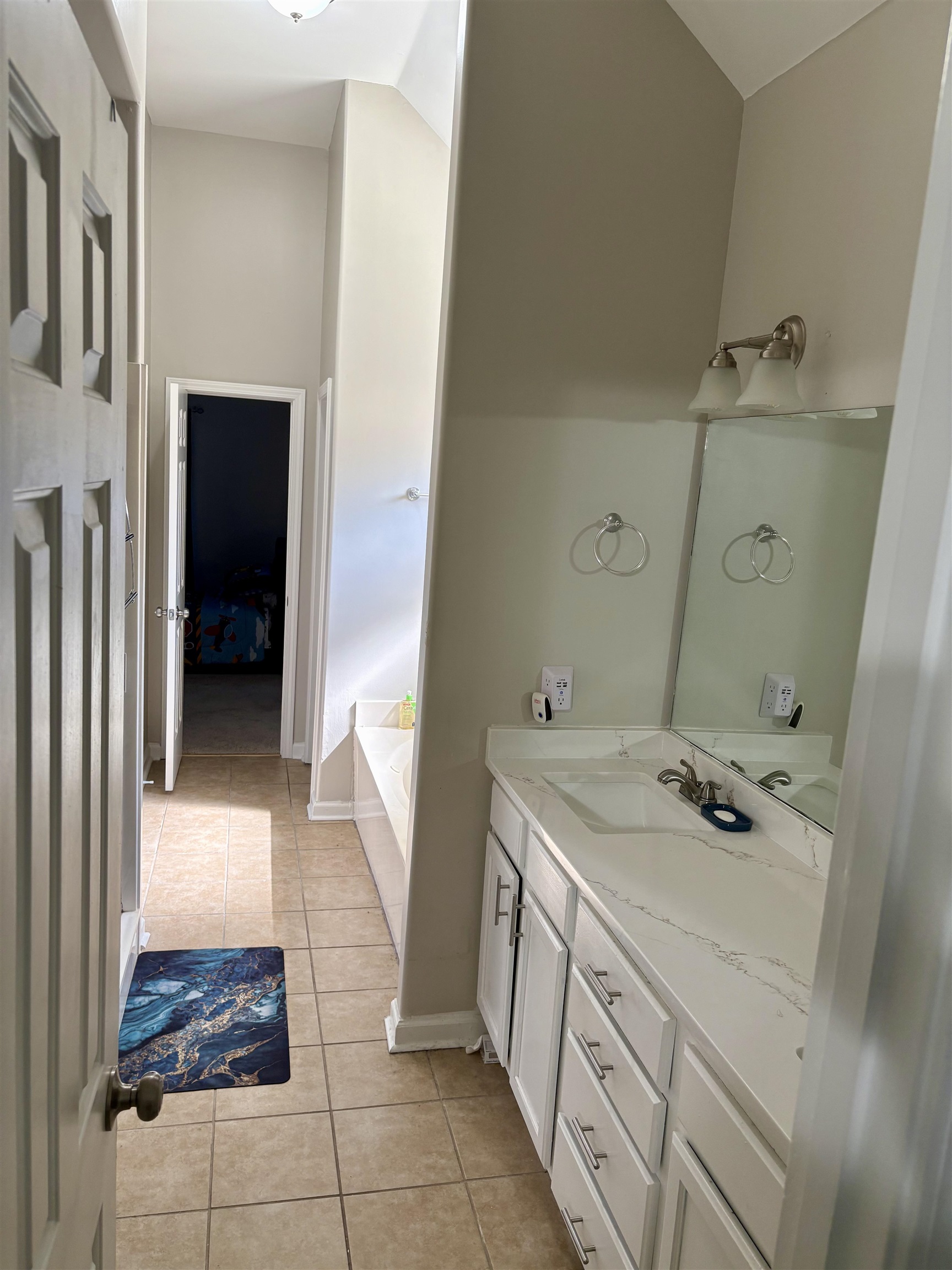 9107 Raspberry Lane Cordova, TN 38016 - Photo 17 of 26 Bathroom with a garden tub, vanity, and light tile patterned floors
