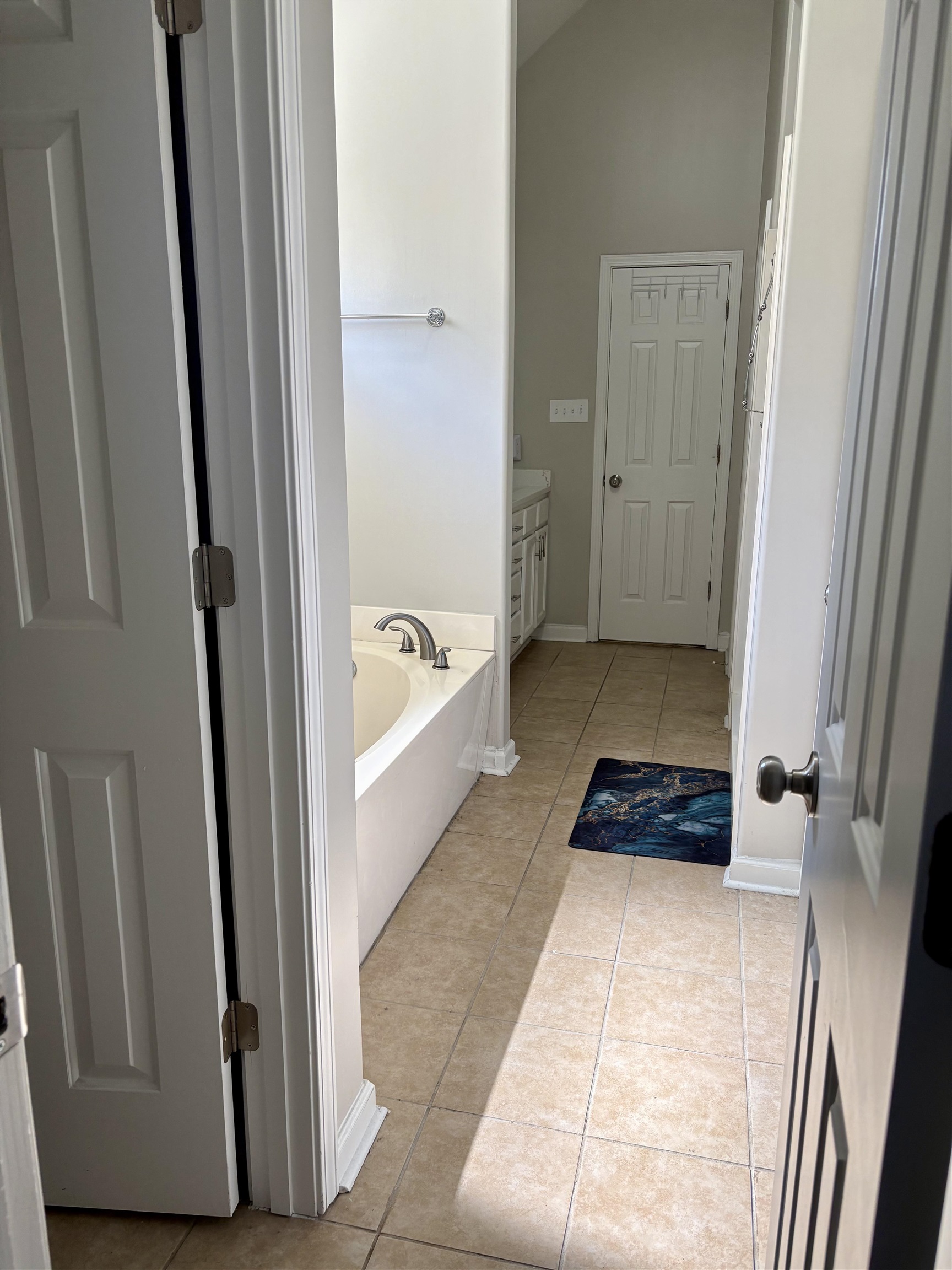 9107 Raspberry Lane Cordova, TN 38016 - Photo 18 of 26 Full bath featuring a bath, light tile patterned floors, lofted ceiling, and vanity