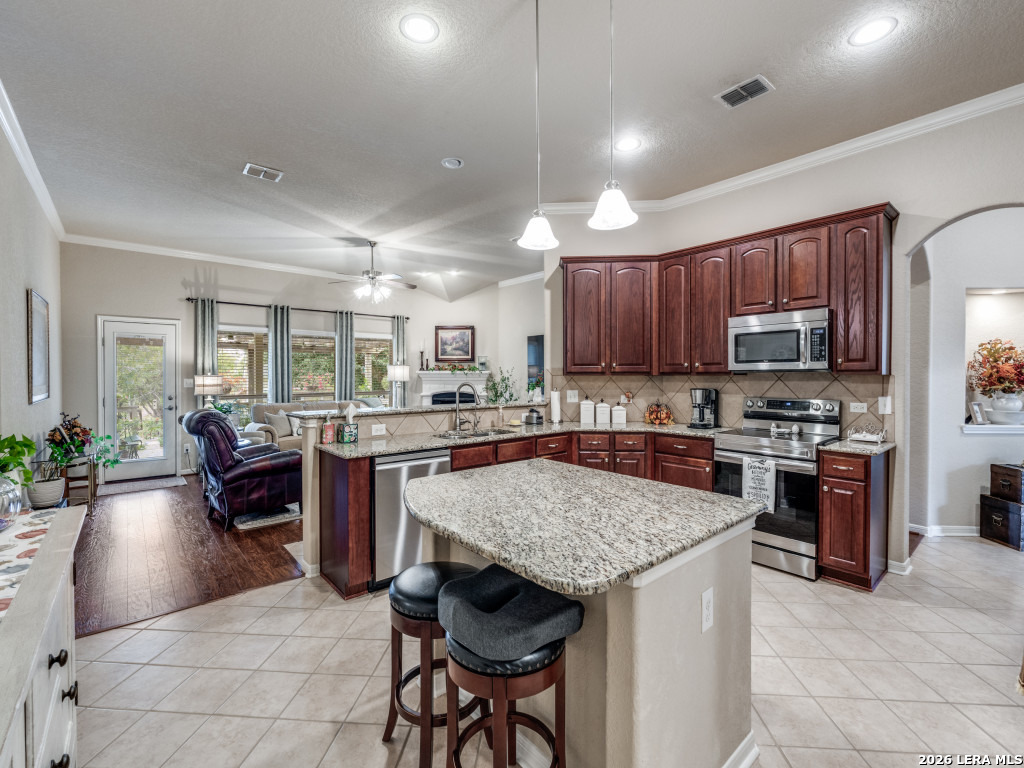 6050 Covers Schertz, TX 78108 - Photo 11 of 25 a kitchen with stainless steel appliances granite countertop a stove top oven a sink dishwasher and cabinets with wooden floor