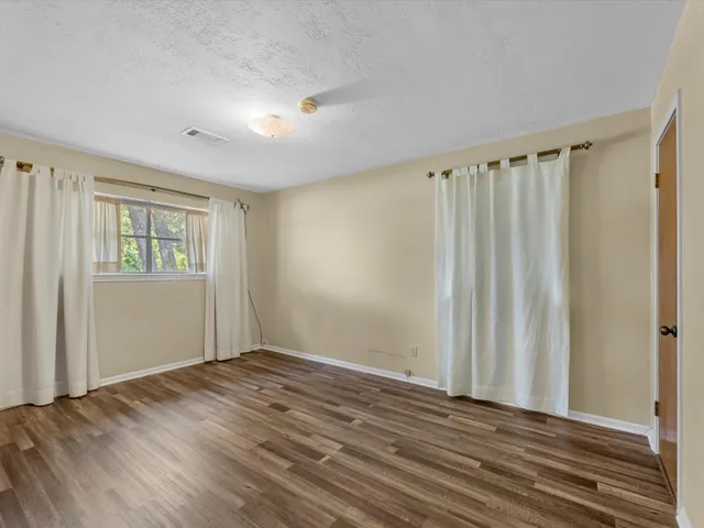 a view of a room with wooden floor and walls