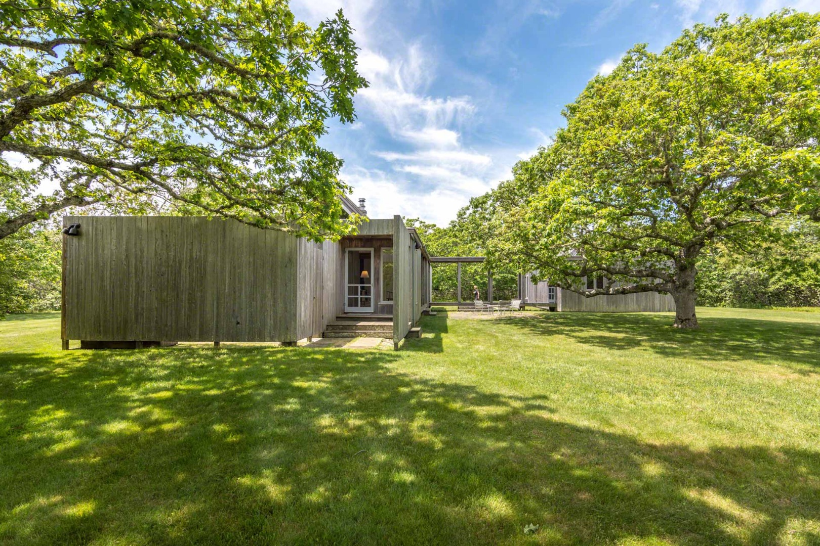 7 Black Point Road Chilmark, MA 02535 - Photo 43 of 44 a backyard of a house with table and chairs