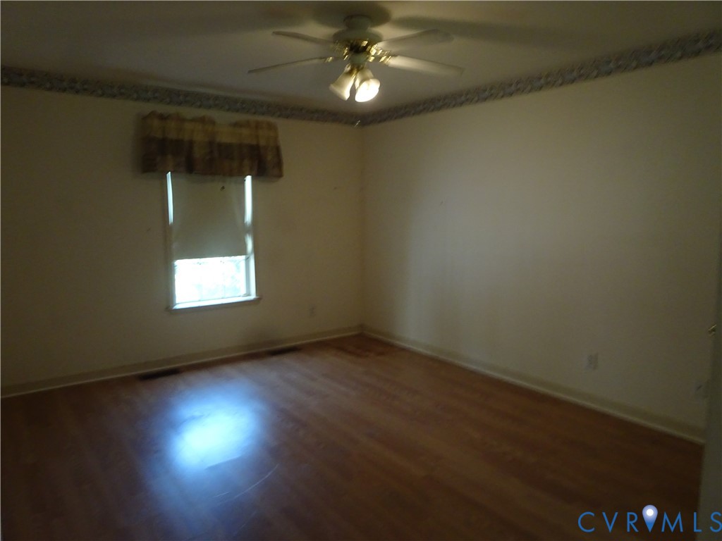 21020 River Road Sutherland, VA 23885 - Photo 9 of 15 Empty room with wood finished floors and a ceiling