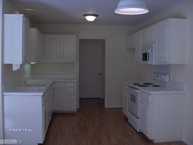 5306 Chestnut Ridge Drive Summerfield, NC 27358 - Photo 11 of 15 Kitchen. Fresh paint, clean, new laminate wood flooring