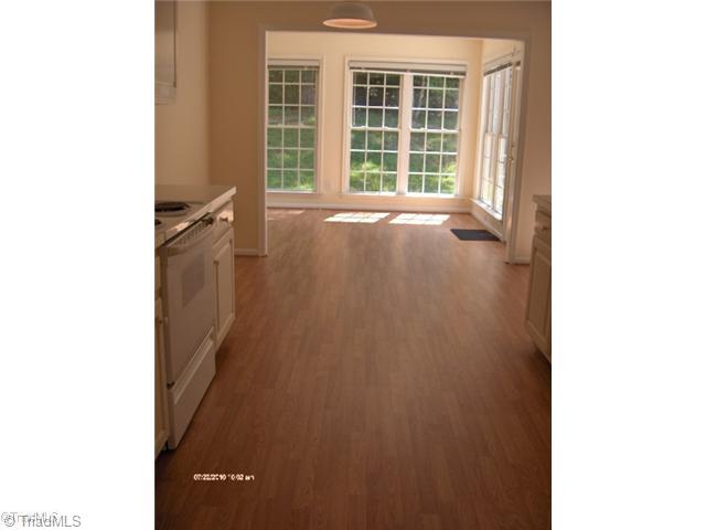 5306 Chestnut Ridge Drive Summerfield, NC 27358 - Photo 14 of 15 Breakfast. Kitchen opens to Breakfast room which opens to Family room on one side and Sunroom on other side