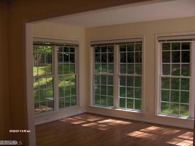 5306 Chestnut Ridge Drive Summerfield, NC 27358 - Photo 4 of 15 Sunroom. Full privacy view in bright sunroom with new laminate wood flooring & fresh paint