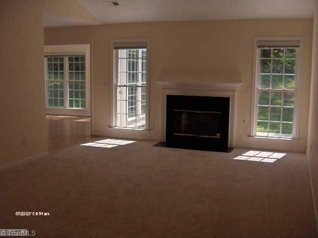 5306 Chestnut Ridge Drive Summerfield, NC 27358 - Photo 6 of 15 Den/Family/Great Room. Vaulted ceiling with ceiling fan and Fireplace with gas logs