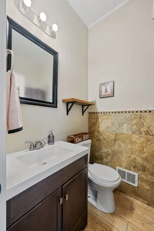 a bathroom with a sink toilet and mirror