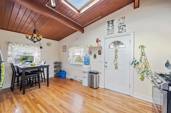 a view of a dining room with furniture and wooden floor