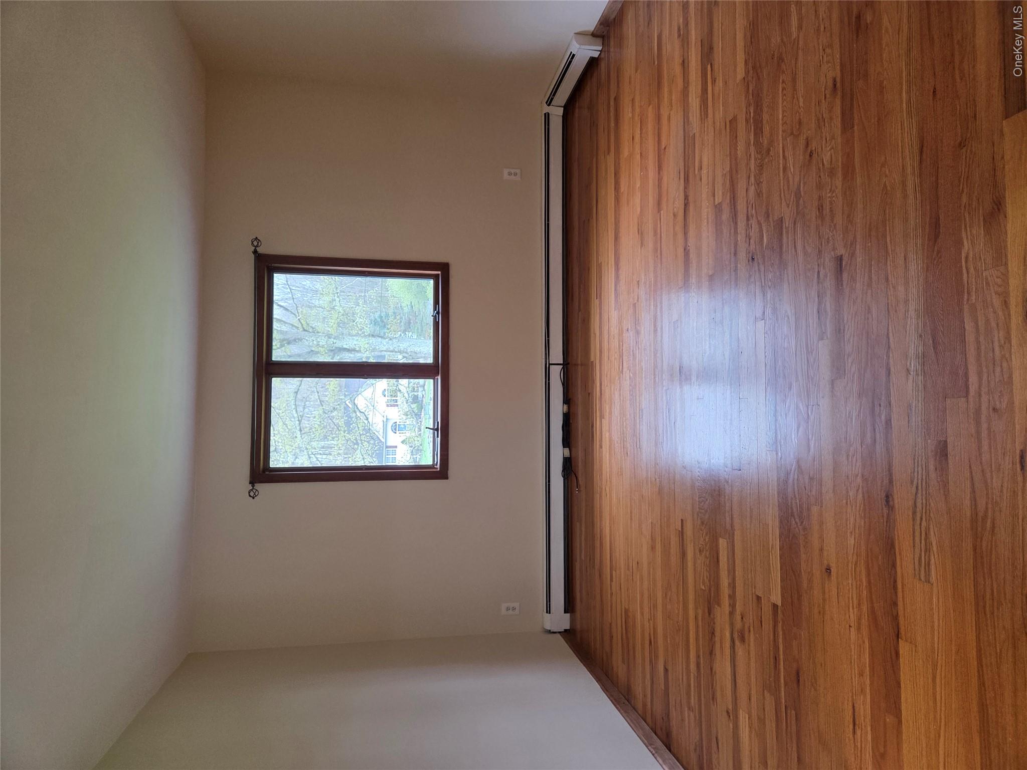 193 Overhill Road, Unit R Stormville, NY 12582 - Photo 6 of 10 a view of an empty room with wooden floor and a window