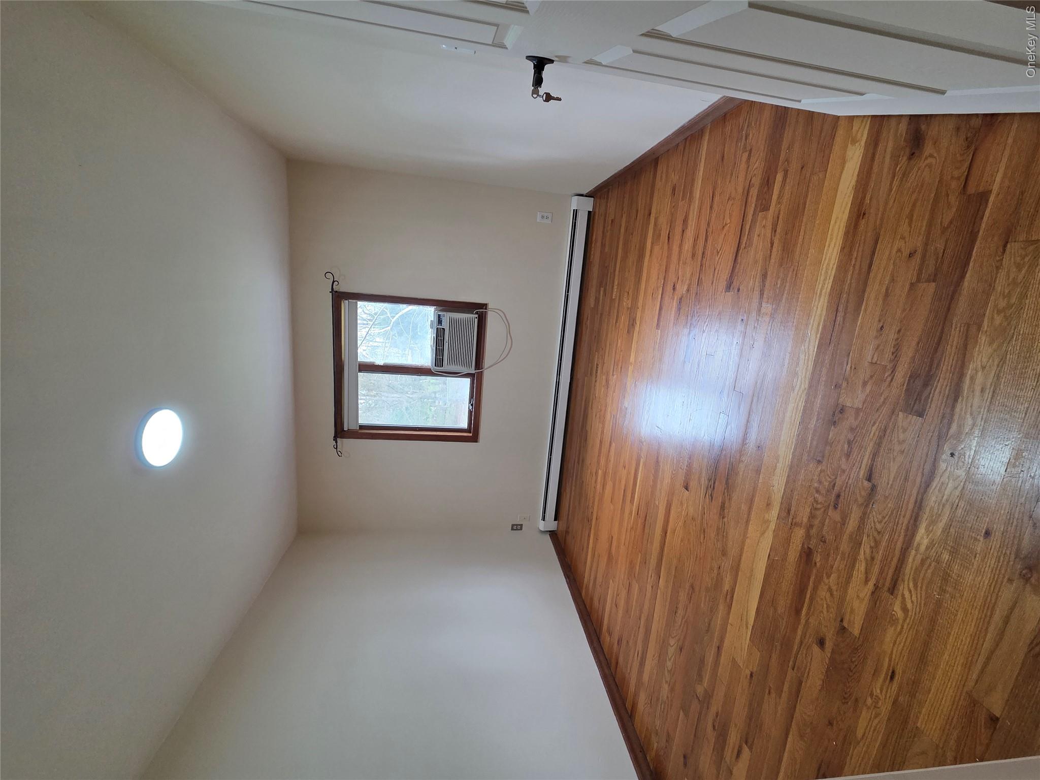 193 Overhill Road, Unit R Stormville, NY 12582 - Photo 9 of 10 an empty room with wooden floor and windows