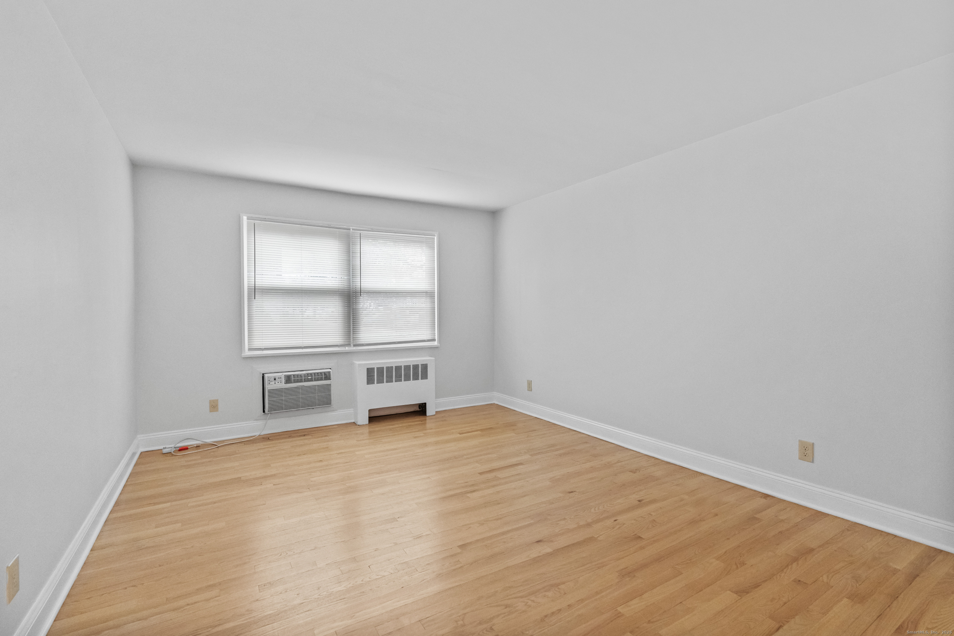 66 Blachley Road, Unit C Stamford, CT 06902 - Photo 11 of 26 wooden floor in an empty room with a window