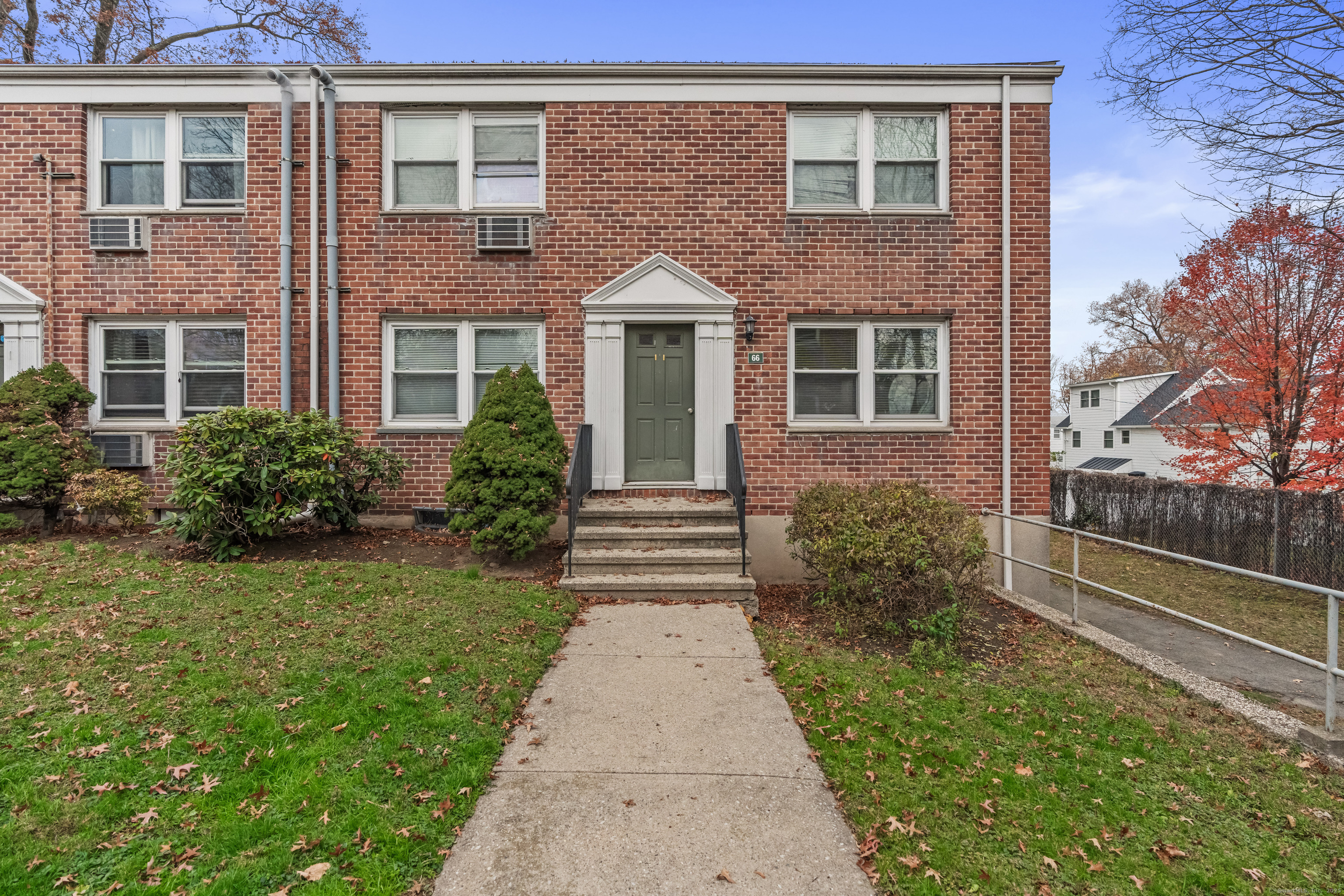 66 Blachley Road, Unit C Stamford, CT 06902 - Photo 3 of 26 a front view of a house with garden