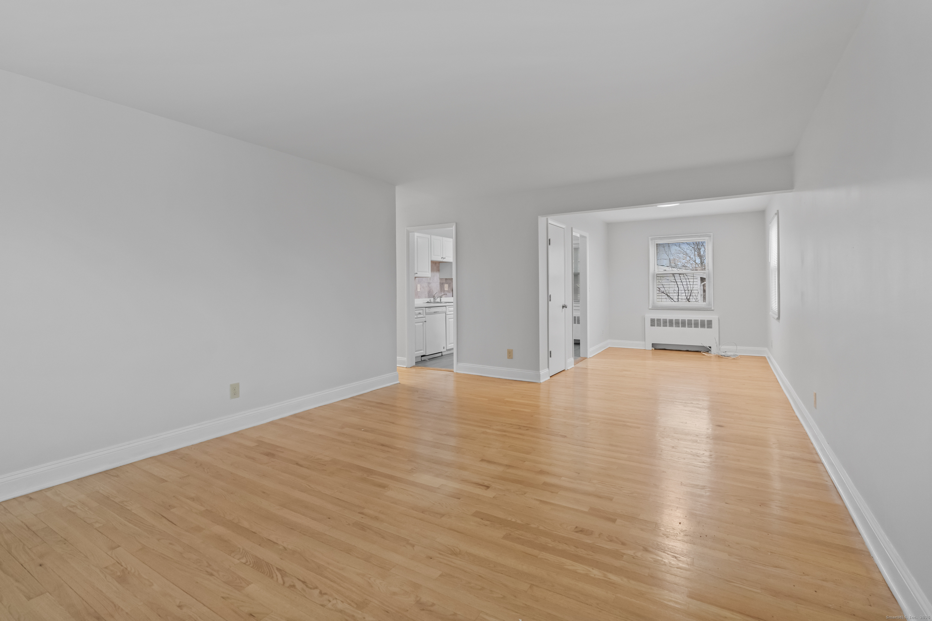 66 Blachley Road, Unit C Stamford, CT 06902 - Photo 4 of 26 a view of empty room with wooden floor