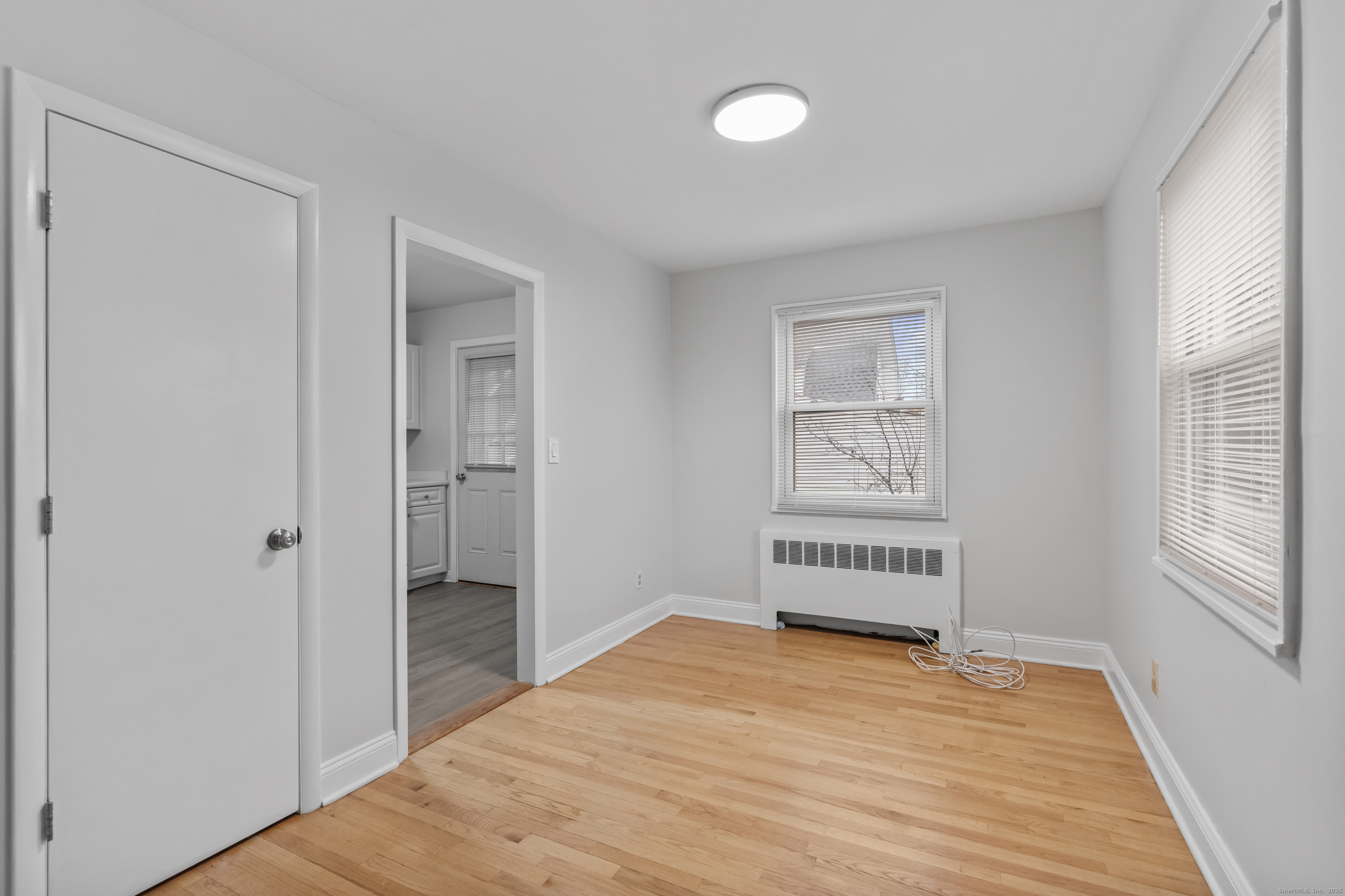 66 Blachley Road, Unit C Stamford, CT 06902 - Photo 7 of 26 wooden floor in an empty room with a window