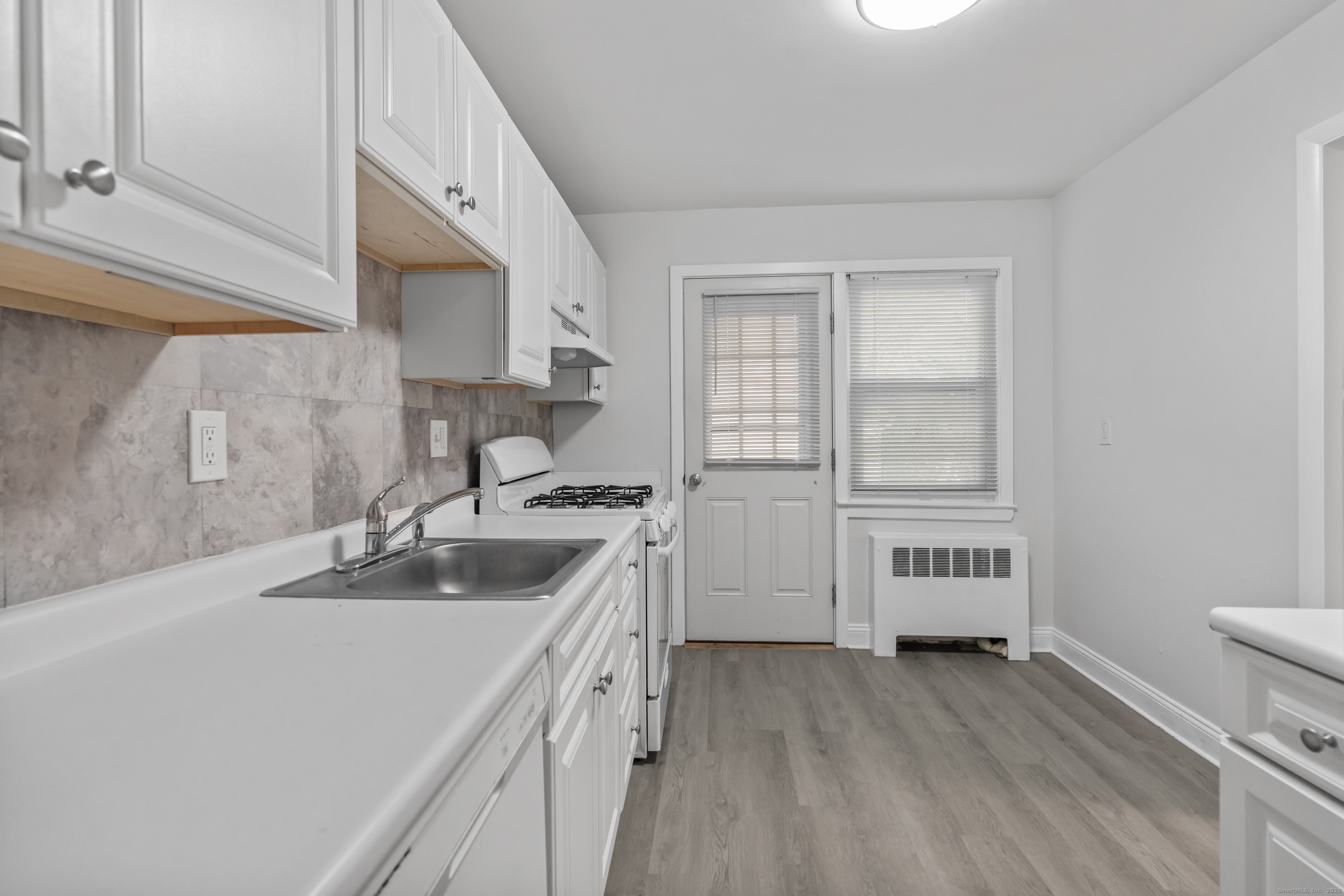 66 Blachley Road, Unit C Stamford, CT 06902 - Photo 9 of 26 a kitchen with a sink and a stove top oven