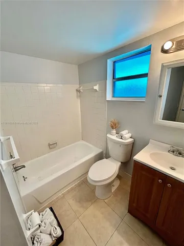 a bathroom with a sink a toilet and bathtub