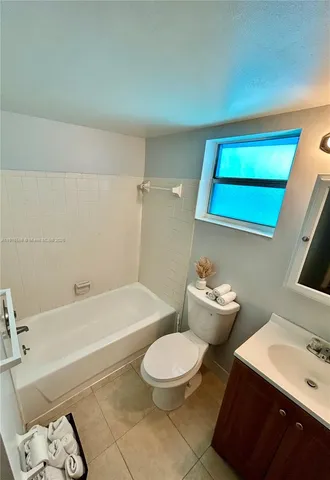 a bathroom with a sink toilet and tub