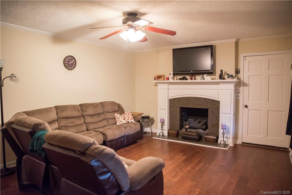 101 Sycamore Road, Unit 209 Salisbury, NC 28147 - Photo 13 of 33 a living room with furniture a flat screen tv and a fireplace