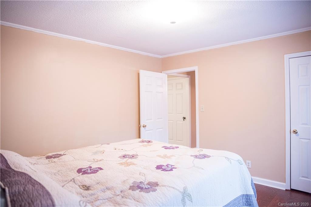 101 Sycamore Road, Unit 209 Salisbury, NC 28147 - Photo 16 of 33 a bedroom with a bed and a wooden floor