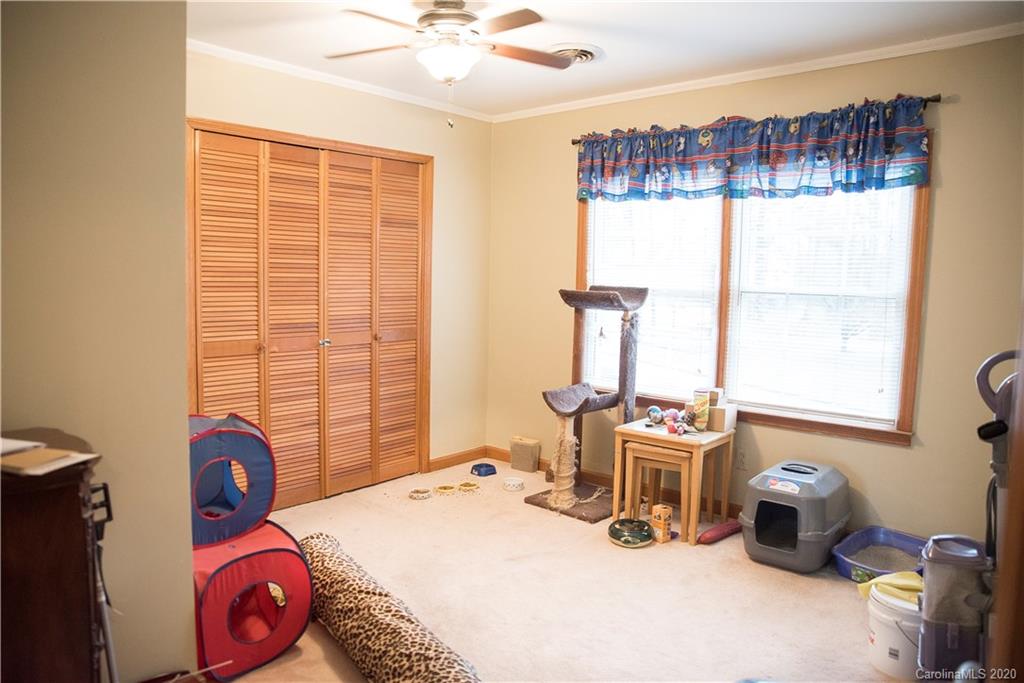 101 Sycamore Road, Unit 209 Salisbury, NC 28147 - Photo 21 of 33 a bed room with a bed and a window