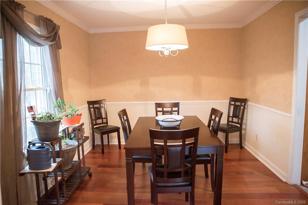 101 Sycamore Road, Unit 209 Salisbury, NC 28147 - Photo 9 of 33 a view of a dining room with furniture window and wooden floor