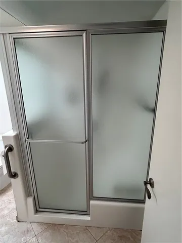 a bathroom with a glass shower door