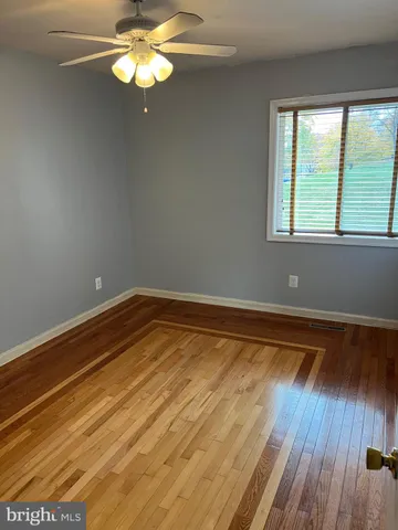 a view of room with window and wooden floor