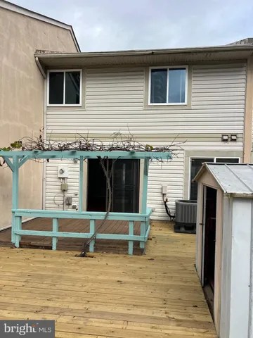 an empty room with wooden floor and mirror