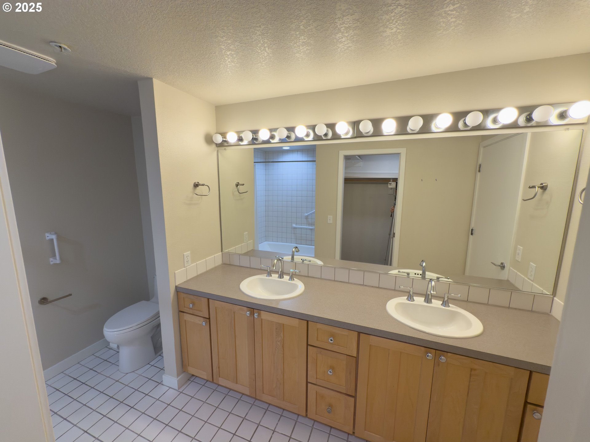 2327 Northwest Northrup Street, Unit 8 Portland, OR 97210 - Photo 11 of 33 a bathroom with a double vanity sink and a mirror