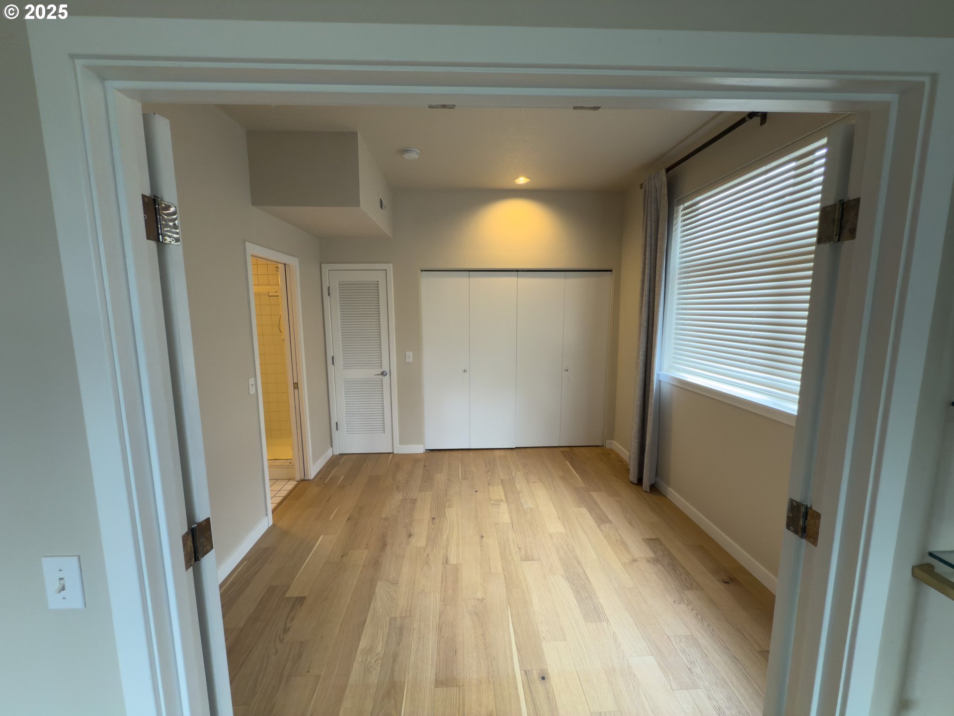 2327 Northwest Northrup Street, Unit 8 Portland, OR 97210 - Photo 17 of 33 a view of empty room with wooden floor