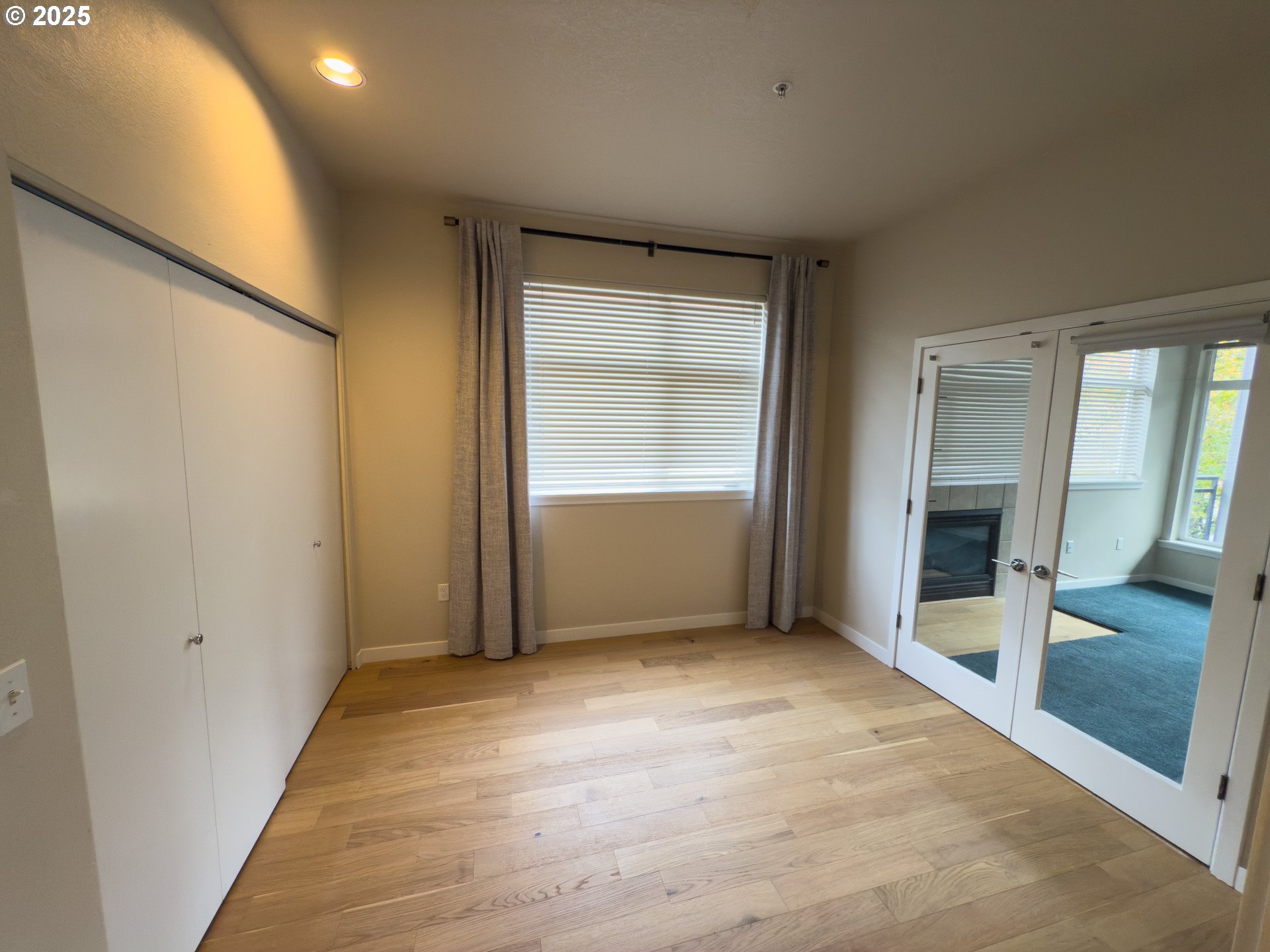 2327 Northwest Northrup Street, Unit 8 Portland, OR 97210 - Photo 20 of 33 an empty room with wooden floor and windows