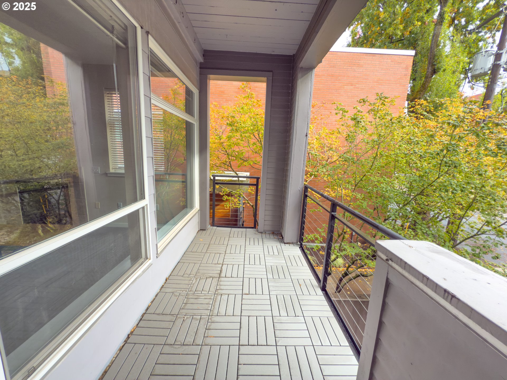 2327 Northwest Northrup Street, Unit 8 Portland, OR 97210 - Photo 25 of 33 a view of a balcony with wooden floor and iron stairs