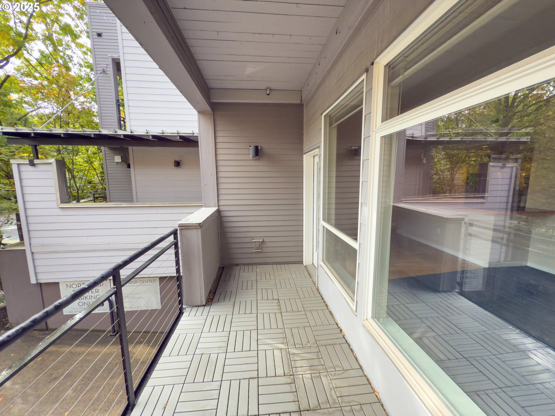 2327 Northwest Northrup Street, Unit 8 Portland, OR 97210 - Photo 26 of 33 a view of a balcony with wooden floor and iron stairs