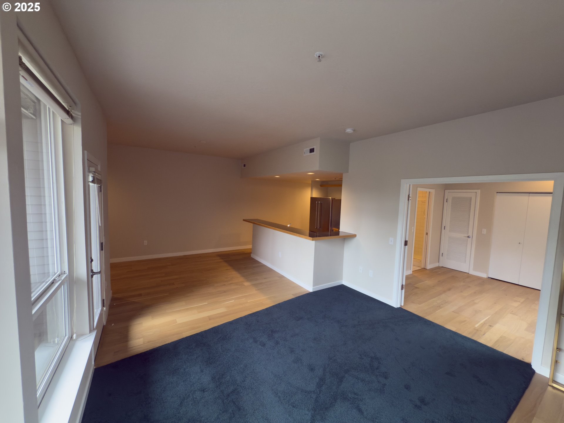 2327 Northwest Northrup Street, Unit 8 Portland, OR 97210 - Photo 4 of 33 a view of empty room with wooden floor