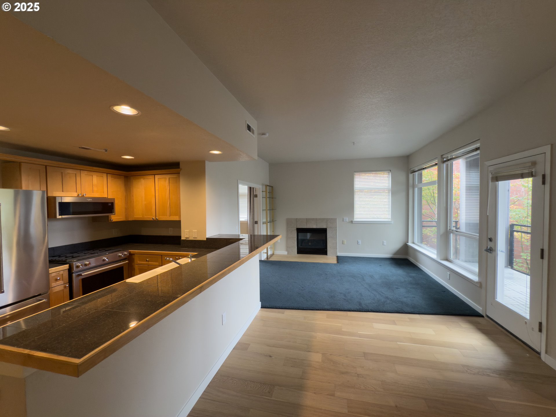 2327 Northwest Northrup Street, Unit 8 Portland, OR 97210 - Photo 5 of 33 a kitchen with stainless steel appliances granite countertop a sink and a stove
