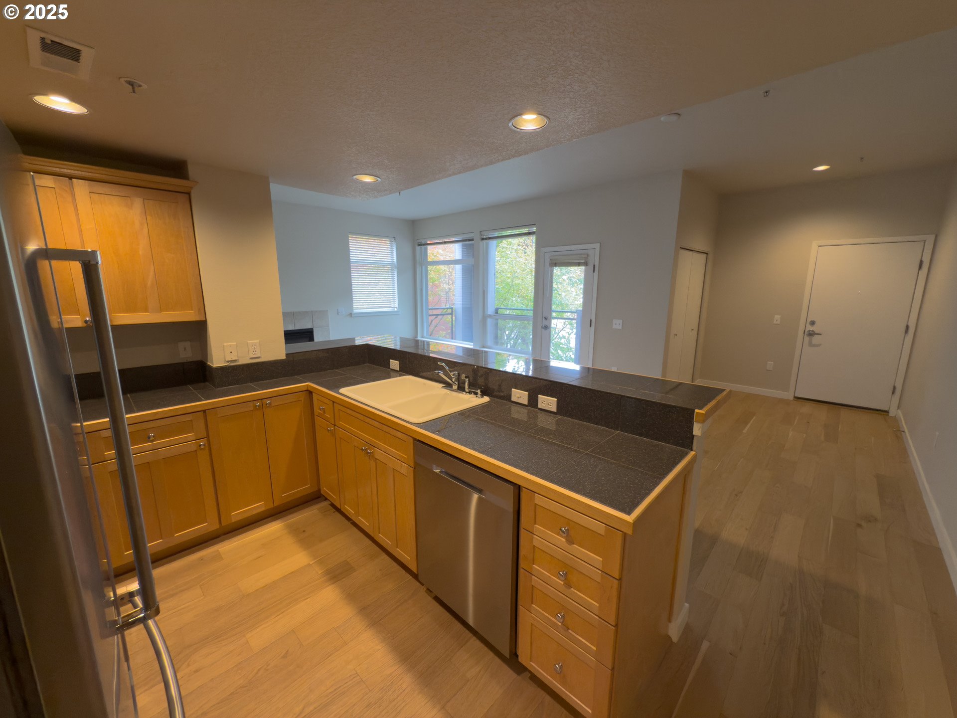2327 Northwest Northrup Street, Unit 8 Portland, OR 97210 - Photo 8 of 33 a kitchen with stainless steel appliances granite countertop a sink stove and cabinets