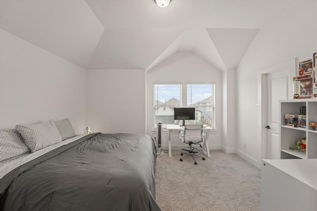 1714 Highwood Road Forney, TX 75126 - Photo 17 of 30 Vaulted ceiling with a flush-mount light fixture, white walls, and light-toned carpeting