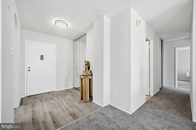 a view of a dining room with furniture and a chandelier