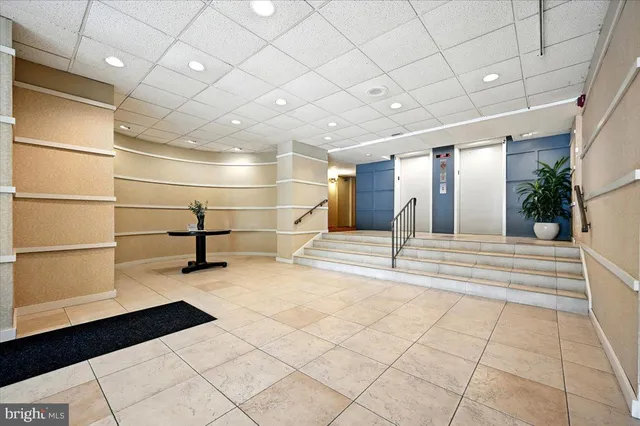 a bedroom with bed a table and chair