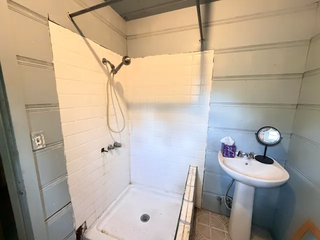 a bathroom with a sink and shower
