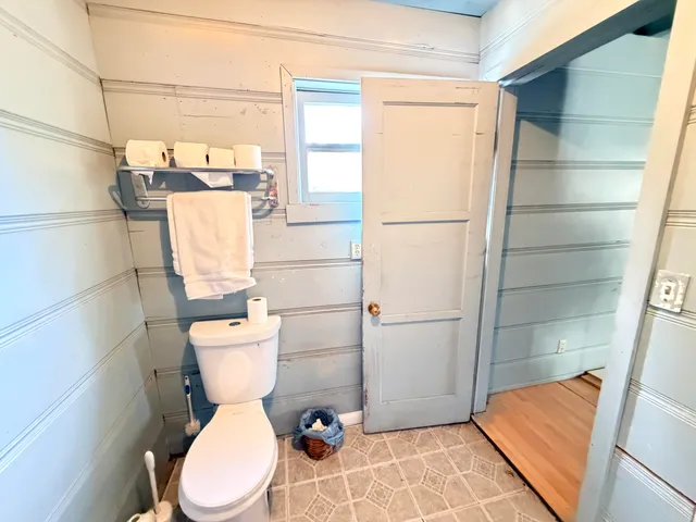 a white toilet sitting next to a bathroom sink