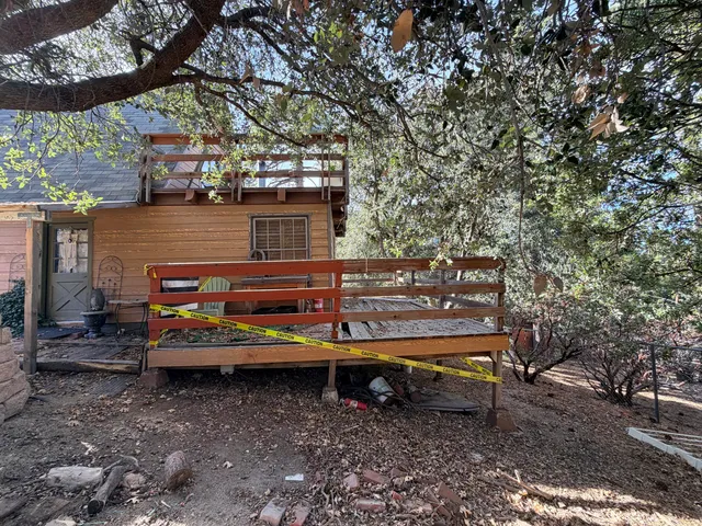 a view of a wooden bench with chairs in the patio
