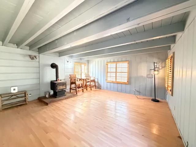 a view of a bedroom with furniture and a window