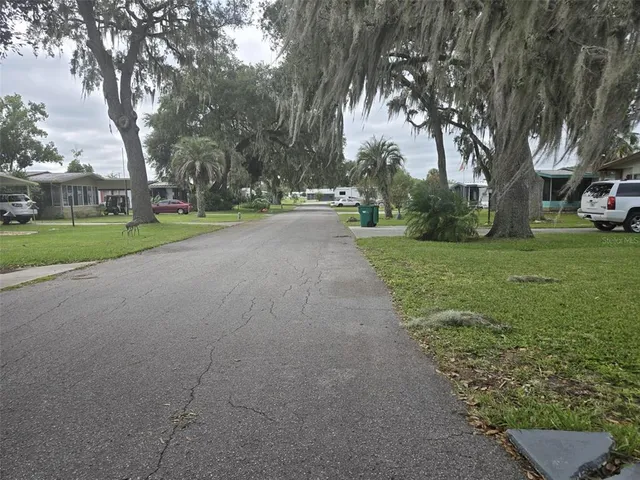 a view of a street with a house in the background