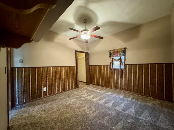a view of a livingroom with a ceiling fan and a window