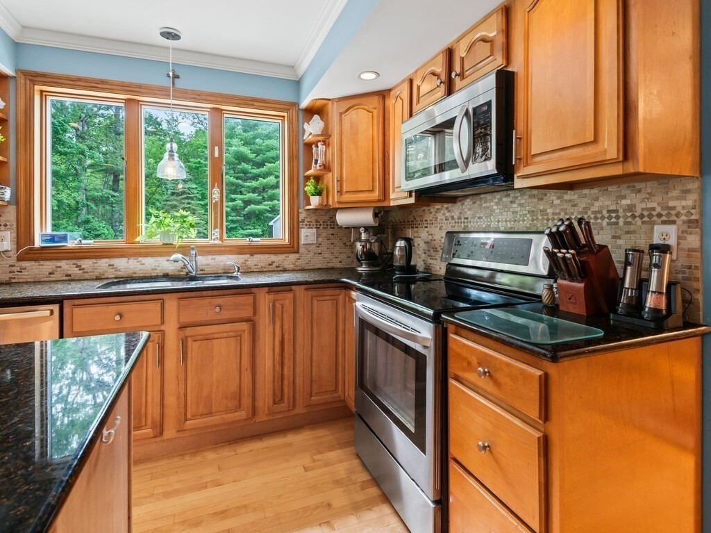 9 Santom Street Auburn, MA 01501 - Photo 5 of 42 a kitchen with stainless steel appliances granite countertop a stove a sink and a microwave