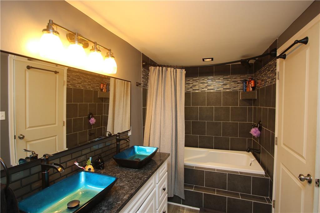 290 Lincoln Hall Road Elizabeth, PA 15037 - Photo 11 of 24 Master EnSuite Full Bath Features Double Glass Bowl Sinks, Granite Counter Tops, Built-in Linen Closet & Jet Spray Tub with Ceramic Tile Surround.