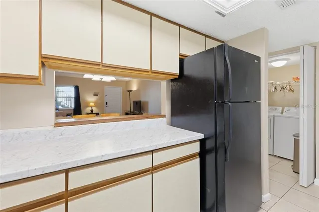a kitchen with stainless steel appliances a refrigerator and cabinets