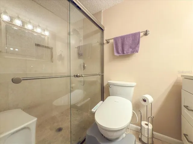 a bathroom with a toilet and a shower